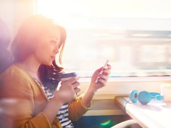 Woman on a commuter train looking at her phone.