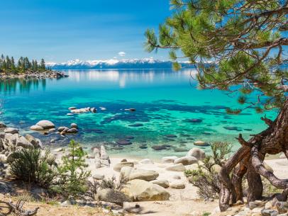 A view looking at the snow-capped mountains and lake at Sand Harbor, Nevada.