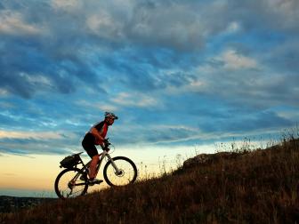 Silhouette of a bike on sky background on sunset