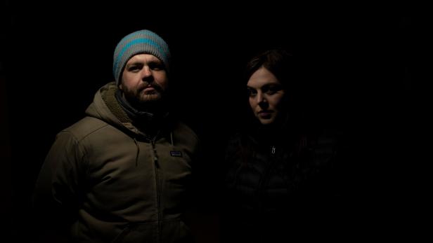 Hosts Jack Osbourne and Katrina Weidman posing for a photo in front of a black background. As seen on Travel Channel's Portals To Hell.